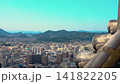 Japanese Castle Roof and Expansive City Skyline Timelapse 4k View Overlooking Coastal Urban Landscape with Distant Mountains and Sea on a Sunny Clear Afternoon 141822205