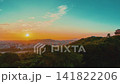 Japanese Castle Timelapse Drone View Overlooking City Skyline at Sunset Transitioning to Twilight Nightscape with Illuminated Architecture and Glowing Urban Infrastructure 4k 141822206