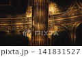 Aerial top down view of a city highway interchange at night with moving cars and bright lights 141831527
