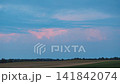 Cumulus storm clouds growing in the night sky 141842074