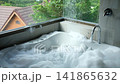 Modern Luxury Bathroom With Bathtub Filled with Soap Foam and Rain Showerhead 141865632