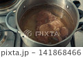 Beef marrow bone simmering in a pot of hot water 141868466