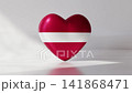A heart shaped object appears with the colors and design of the Latvia flag. It gently rotates against a simple background, showing the red and white colors clearly 141868471