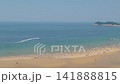 Aerial View of Crowded Summer Beach with Colorful Parasols and Blue Sea 141888815