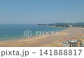Aerial View of Crowded Summer Beach with Colorful Parasols and Blue Sea 141888817