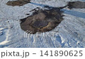 Steam rises from manholes on a winter city street 141890625