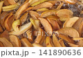 Stirring with a spoon, we cook a compote of dried fruits in a saucepan 141890636