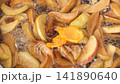Boiling: Prepare a compote of dried fruits in a saucepan 141890640
