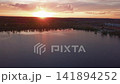 Beautiful sunset with clouds over the river under construction houses in the dark, Ukraine, Kiev on May 6. 141894252