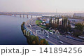 Flight over the highway, along the river and the industrial zone on the other side against the background of a railway bridge autumn, Kiev Ukraine. 141894256