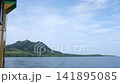 Ferry Boat Sailing Across Ocean Towards Tropical Green Mountain near Lanta Island 141895085