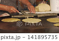 Street food vendor preparing tacos and quesadillas 141895735