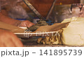 Cook shaping handmade tortilla dough before pressing and cooking 141895739