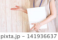 A businesswoman extends her right hand. 141936637