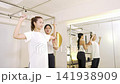 A woman receiving personal training and strength training instruction. A woman receiving personal training and strength training instruction. 141938909