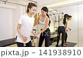 A woman receiving personal training and strength training instruction. A woman receiving personal training and strength training instruction. 141938910