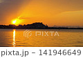 Fast motion time lapse of the solar eclipse 2026 over Denia port in Spain. Dramatic clouds moving over the Mediterranean sea as the eclipse sun sets behind the castle and city skyline during dusk. 141946649