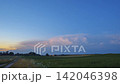 Cumulus storm clouds growing in the night sky 142046398