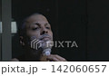 Man shaving facial hair with manual razor in bathroom 142060657