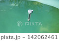 Floating thermometer bobbing in swimming pool 142062461