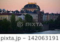 The National Theatre and riverside facades along the Vltava River at dawn, with a stone bridge below, Prague, Czech Republic 142063191