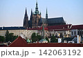 Prague Castle and the Gothic spires of St. Vitus Cathedral above red rooftops at dusk, Prague, Czech Republic 142063192
