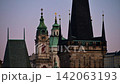 The Gothic Lesser Town Bridge Tower with the clock tower and dome of St. Nicholas Church behind, Prague, Czech Republic 142063193