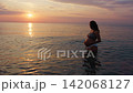 Pregnant Woman Taking A Bath At Sunset Pregnant Woman Taking A Bath At Sunset 142068127