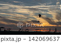 Powered Paraglider Flying Over Sea Sunset 142069637