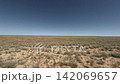 Off-road driving through expansive grassland terrain under clear blue sky 142069657