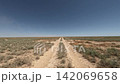 Off-road driving on dusty trail through open landscape with blue sky 142069658