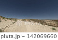 Off-road driving through rugged terrain with dirt path and clear blue sky 142069660