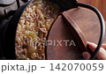 Cooking beef bowl ingredients in an iron pot (vertical video) 142070059