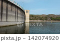 Slow motion pan shot from the massive concrete dam wall of Beniarres reservoir (Embalse de Beniarres) to the calm water and scenic mountain landscape. Engineering structure and water resource manageme 142074920
