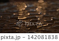 Sunset sunlight shines on transparent raindrops on a wooden surface, blurry background 142081838