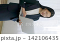 A young Japanese businesswoman using her laptop by the window (vertical video) 142106435