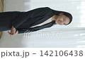 A young Japanese businesswoman smiling by a window (vertical video) 142106438