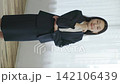 A young Japanese businesswoman smiling by a window (vertical video) 142106439