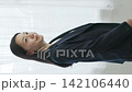 A young Japanese businesswoman smiling by a window (vertical video) 142106440