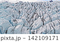 Cinematic aerial flight above the spectacular glacier front of Fjallsarlon Glacier Lagoon in Iceland, revealing deep crevasses, blue glacial ice and the dramatic landscape of Vatnajokull. Cinematic aerial flight above the spectacular glacier front of Fjallsarlon Glacier Lagoon in Iceland, revealing deep crevasses, blue glacial ice and the dramatic landscape of Vatnajokull. 142109171