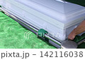 Ceremony takes place at cemetery with white coffin placed during funeral ceremony 142116038