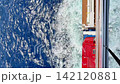 The blue sea and white wake viewed from the balcony of a cruise ship. 142120881