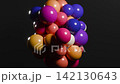 Colorful glossy spheres cluster and rotate against dark background 142130643