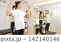 A woman receiving personal training and strength training instruction. A woman receiving personal training and strength training instruction. 142140146
