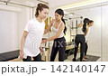 A woman receiving personal training and strength training instruction. A woman receiving personal training and strength training instruction. 142140147