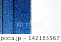 Abstract background Blue denim fabric showing detailed woven texture, Seams and contrasting stitching for textile and fashion backgrounds 142183567