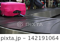 Suitcases being moved around on baggage conveyor at an airport, 4k 142191064