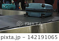 People standing around the airport baggage conveyor as suitcases being moved, 4k 142191065