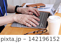 A person who operates a laptop 142196152