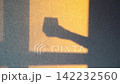 Static Shot Of Human Arm Shadow Extending Across Sunlit Textured Wall In Interior Space During 142232560